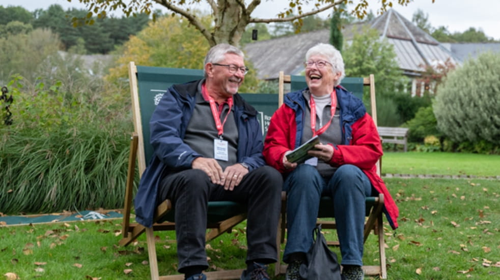 Two boundless members sitting in a deckchair at RHS Harlow Carr